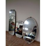 An Edwardian chrome framed oval bevel edged mirror together with two frameless mirrors