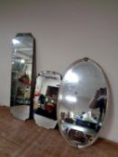 An Edwardian chrome framed oval bevel edged mirror together with two frameless mirrors