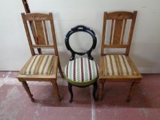 A pair of early 20th century oak dining chairs together with an ebonised bedroom chair