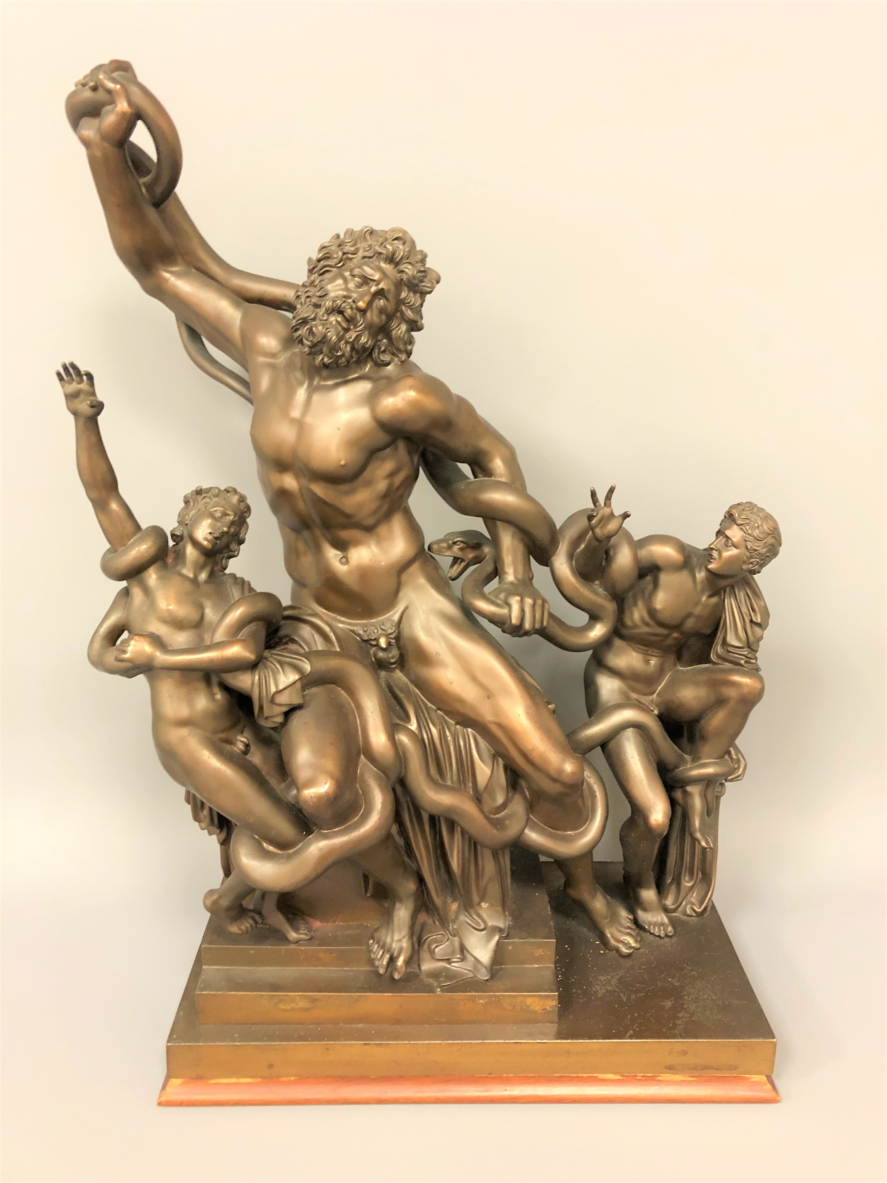 An impressive bronze sculpture depicting Laocoön and his sons being killed by serpents.