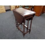 A 20th century oak drop leaf table on bobbin legs