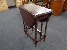 A 20th century oak drop leaf table on bobbin legs