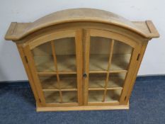 A 20th century blonde oak double door wall cabinet