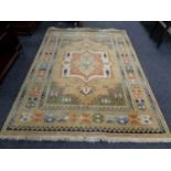 A fringed woolen Persian rug of geometric design,