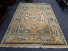 A fringed woolen Persian rug of geometric design,