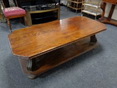 An octagonal oak two tier coffee table