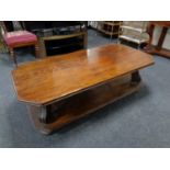 An octagonal oak two tier coffee table