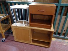 A circular contemporary occasional table on metal legs together with a teak effect bedside stand