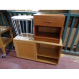 A circular contemporary occasional table on metal legs together with a teak effect bedside stand