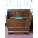 A 19th century continental mahogany barrel fronted bureau fitted three drawers
