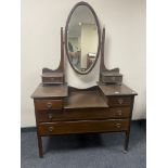 A late Victorian inlaid mahogany sunk centre dressing table with mirror back