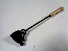 An antique candle snuffer