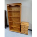 A set of pine open bookshelves together with a pine three drawer bedside chest