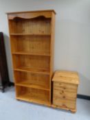 A set of pine open bookshelves together with a pine three drawer bedside chest