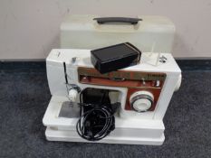 A Singer 6105 electric sewing machine in case (continental wiring)