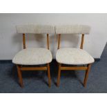 A pair of 20th century teak dining chairs