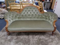 A Victorian inlaid mahogany shaped back settee upholstered in a green button dralon