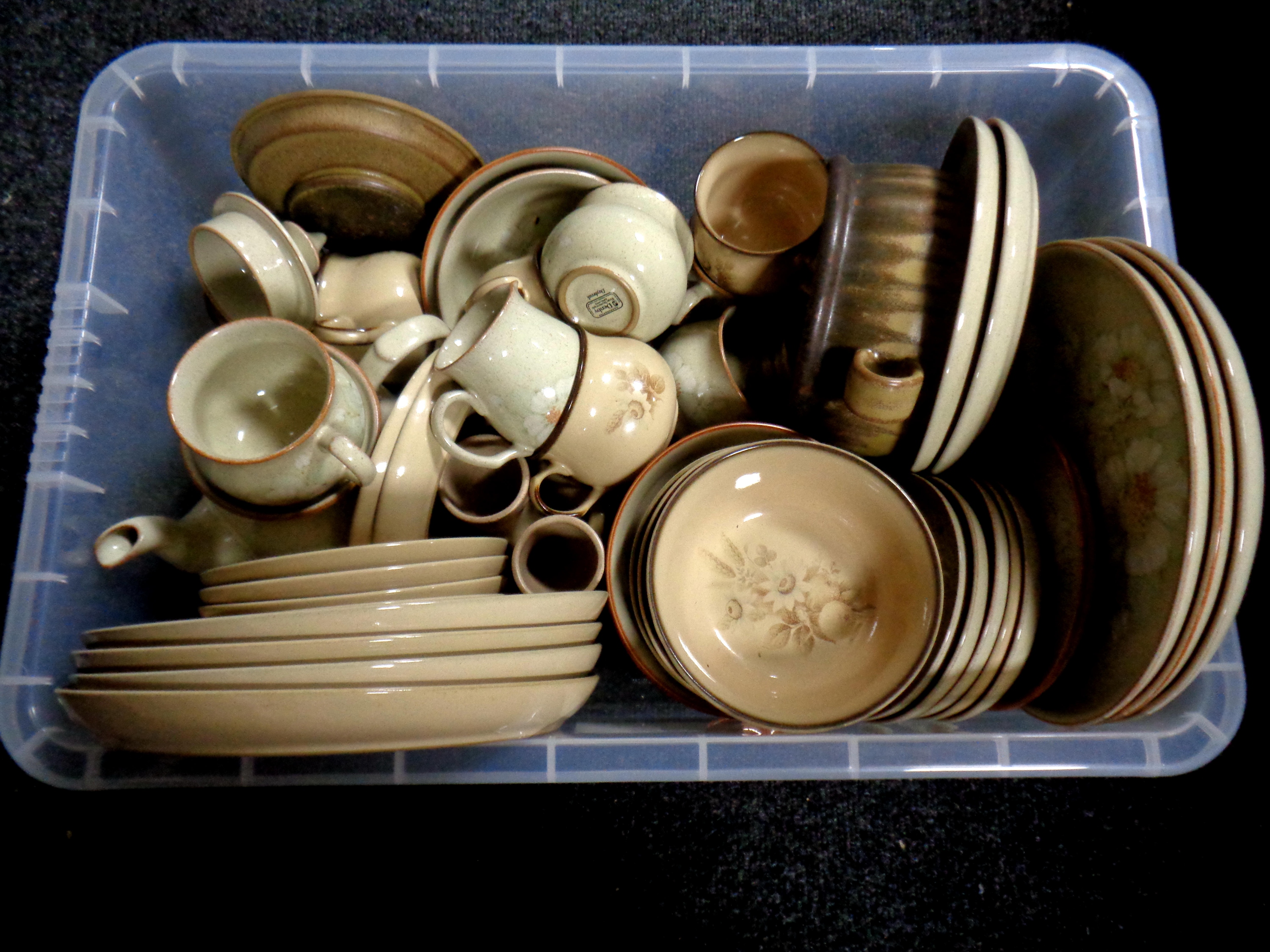 A box containing assorted Denby dinner ware