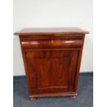 A 19th century mahogany serpentine fronted hall cupboard fitted a drawer