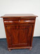 A 19th century mahogany serpentine fronted hall cupboard fitted a drawer