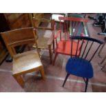 An antique painted kitchen rush seated armchair together with a further spindle back armchair and