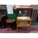 A 20th century two tier tea trolley together with a circular two tier occasional table,