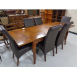A contemporary extending dining table with leaf together with a set of six high backed leather