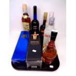 A tray containing seven bottles of alcohol to include Harvey's Bristol Cream, Archer's,