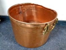 An antique copper brass handled cooking pot,