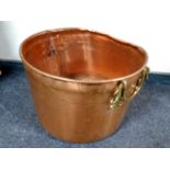 An antique copper brass handled cooking pot,