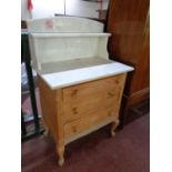 A stripped pine marble topped three drawer wash stand