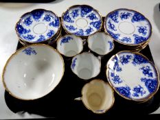 A tray containing thirty-four pieces of 19th century blue and white gilt rimmed tea china