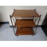 A contemporary wrought iron and pine three tier tea trolley