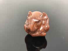 A carved hardwood netsuke - Rat curled into a ball