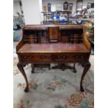 A reproduction mahogany Carlton House style writing desk with a leather inset panel on claw and