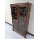 An Edwardian oak leaded glass double door bookcase