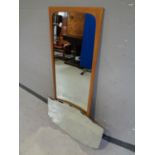 A 1970s teak framed mirror together with a frameless bevel edged mirror