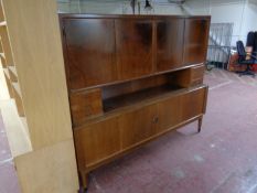 A mid 20th century teak sideboard fitted cupboards and drawers on raised legs