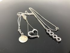 Three silver pendants and chains
