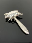 A silver plated child's rattle in the form of a pig