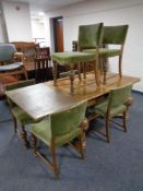 An early 20th century continental pull out dining table on bulbous legs together with a set of six