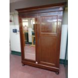 An antique mahogany double door wardrobe