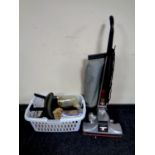 A Kirby Heritage upright vacuum together with a basket containing a large quantity of accessories