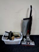 A Kirby Heritage upright vacuum together with a basket containing a large quantity of accessories