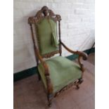 An early 20th century heavily carved oak armchair