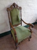 An early 20th century heavily carved oak armchair