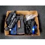 A box containing video cameras in bags, assorted cameras to include Olympus, Garmin sat nav,
