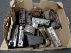 A box of vintage car radios and speedometers