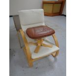 A beech framed relaxer armchair together with a leather footstool