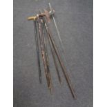 A bundle containing assorted walking sticks to include plated pommel examples, fencing foil,